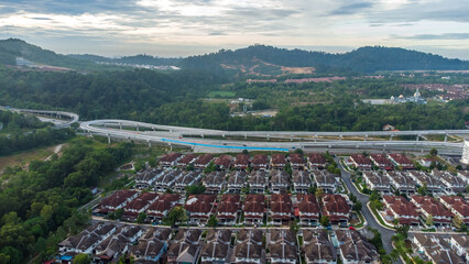 Aerial view of residential area with green asphalt road and residential houses directly above viewpoint. View of suburbs and city district. Real estate and housing market concept. - 601572582