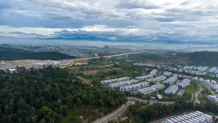 Aerial view of residential area with green asphalt road and residential houses directly above viewpoint. View of suburbs and city district. Real estate and housing market concept. - 601572596