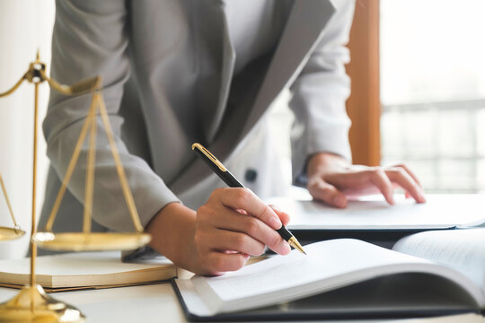 Business woman in suit or lawyer working on a documents.