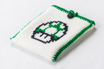 envelope for external hard drive, crocheted with a green mushroom drawn