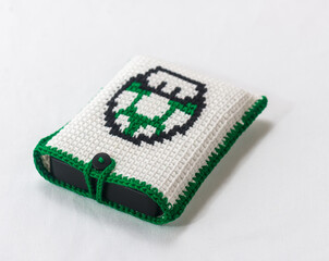 envelope for external hard drive, crocheted with a green mushroom drawn