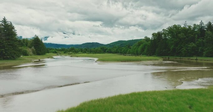 Aerial over estuary rivers and grassy fields