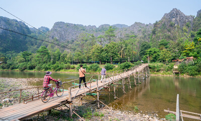 Fototapeta na wymiar Wooden bridge over Nam Song River in Vang Vieng, Laos.