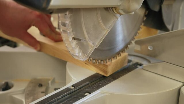 closeup shot of a process of working on wood in the workshop, using a grinding machine. High quality 4k footage