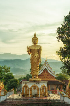 Vertical photo of beautiful buddha image at sunset in Northern, Laos