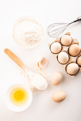 fresh chicken eggs with flour on a white background. cooking