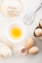fresh chicken eggs with flour on a white background. cooking