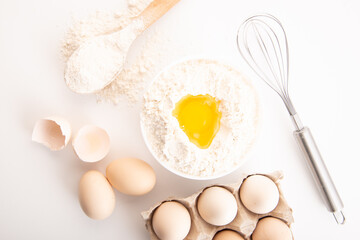 fresh chicken eggs with flour on a white background. cooking