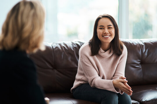 Therapy, happy women have a conversation on sofa and speaking or talking with a psychologist. Mental health or communication, support or consulting and people on couch have a discussion together