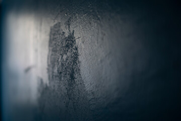 Paint on wall. Light on blue wall. Badly made wall.
