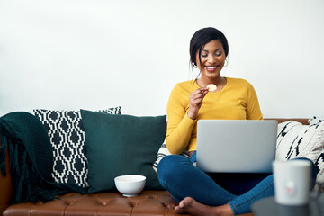 Sofa, laptop and woman eating chips for movie, video streaming service or subscription at home....