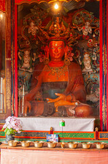 Sikkim, India - 22nd March 2004 : Glass covered colorful Buddist Gods and Godesses, often depicting earlier births of God Buddha, inside Buddhist Andhen or Andey monastery.