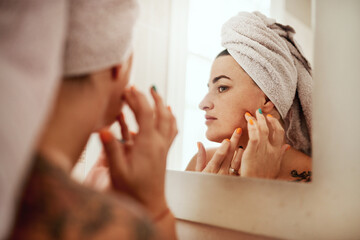 Beauty, acne and woman cleaning her face for skincare morning routine in her bathroom in a home or house. Facial, pimple and female person doing cosmetic self love or care in her house mirror