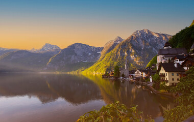 Landmark of tourist view in spring at  Hallstatt, Austria. Mountain village in the Austrian Alps at sunrise sky background