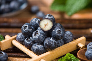 fresh blueberry fruit on wooden table.