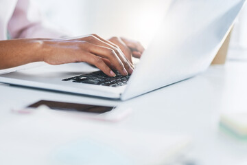 Laptop, typing and hands of business woman in office working on proposal, online document and project. Corporate, computer and closeup of worker on keyboard for writing email, internet and research