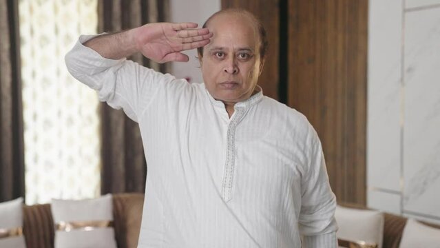 Proud Indian old man saluting