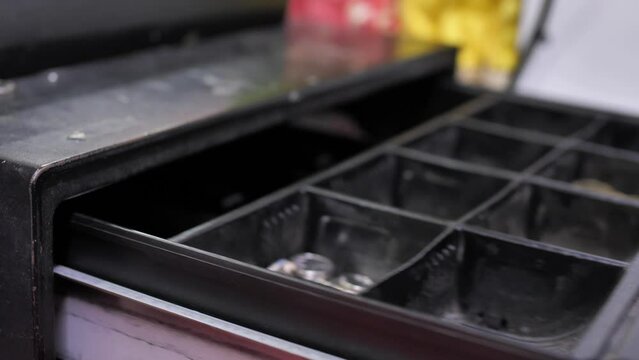 Cashier open cash register drawer machine to give customer change