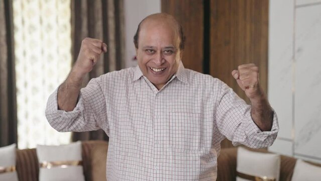 Old Indian uncle cheering and celebrating
