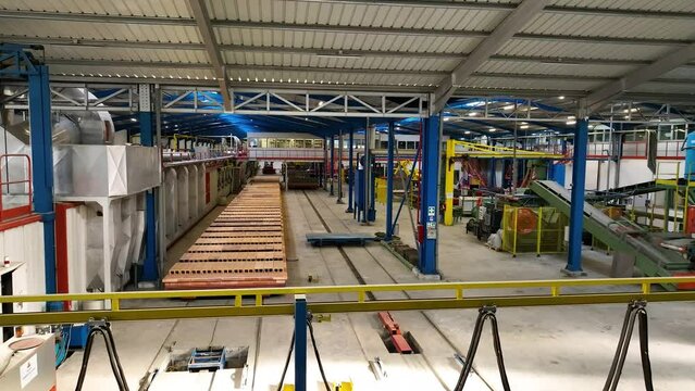 Aerial shot of inside of empty factory with machinery inoperative