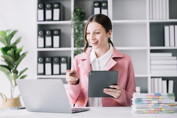 business woman working at office with laptop and documents on his desk, financial adviser analyzing data.