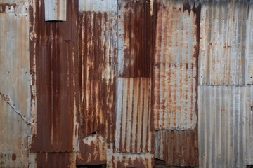 Background made of rusted iron sheet metal and corrugated iron which are fastened together