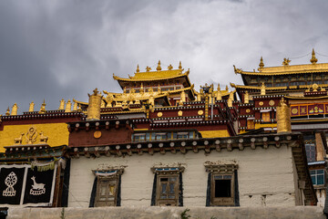 Beautiful view of the Ganden Sumtseling Buddhist Temple. Shangri-La, Tibet, China, close up on the building, background. Capture translation from Chinese: 