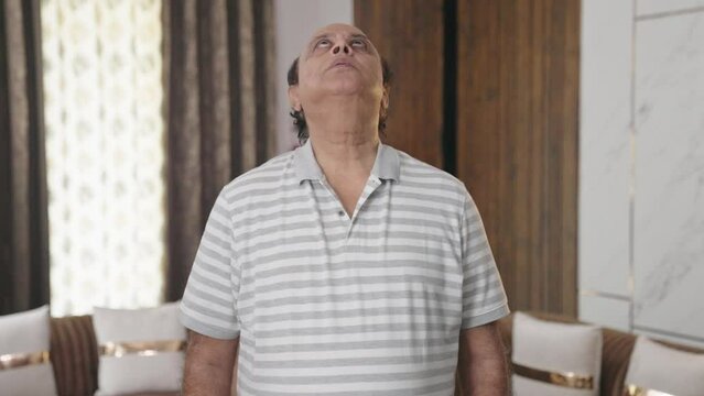 Fat Indian man doing neck exercise