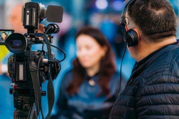 Businesswoman Interviewed by Media at a Trade Fair