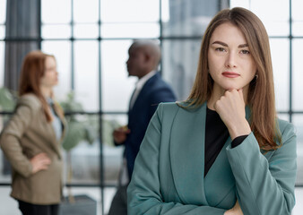 Portrait of a confident young businesswoman standing with her arms crossed in an office