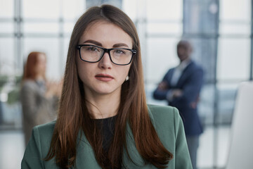 Portrait, Professional and confident millennial businesswoman or female executive manager in formal suit and eyeglasses