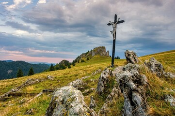 Colorful landscape and beautiful morning.. Cross with Jesus Christ on the meadow in mountains. Kralova studna in Velka Fatra mountains in Slovakia