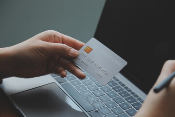 Women holding credit card and using smartphones at home.Online shopping, internet banking, store online, payment, spending money, e-commerce payment at the store, credit card, concept