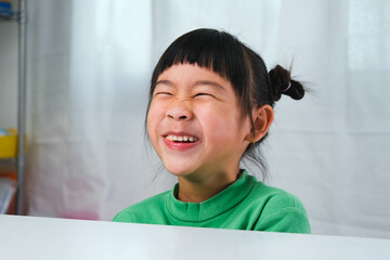 Happy cute little girl eating gelatin candy. Funny kid with chewing gum. Beautiful little girl with...