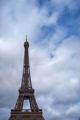 Fototapeta na wymiar Eiffel Tower against the cloudy blue sky