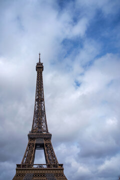 Eiffel Tower against the cloudy blue sky
