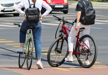 Fototapeta na wymiar Young women on the street with bicycles