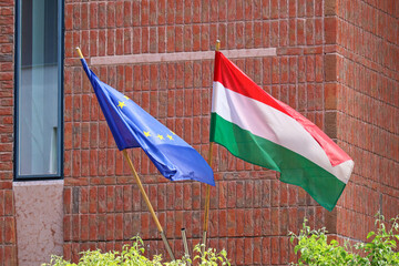 European Union and Hungarian flags on the wall of a building