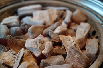 A brazier full of heated charcoal for grilling meat