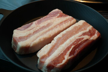 Thick raw pork belly is served.