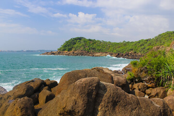 Obraz premium The mound of stones on the seashore. Sri Lanka, blue sky, copy space for text