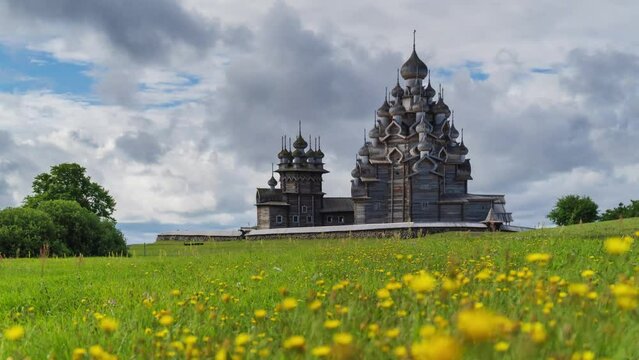Old ortodox Kizhi pogost church in the field at dayligt. Timelapse and religion scene. Dramatic time-lapse of the UNESCO World Heritage.