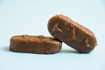 Delicious chocolate bars on a blue background