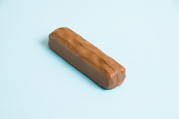 A tasty whole chocolate bar on a blue background