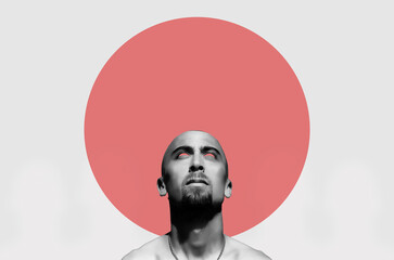 Bearded man looking up on grey background