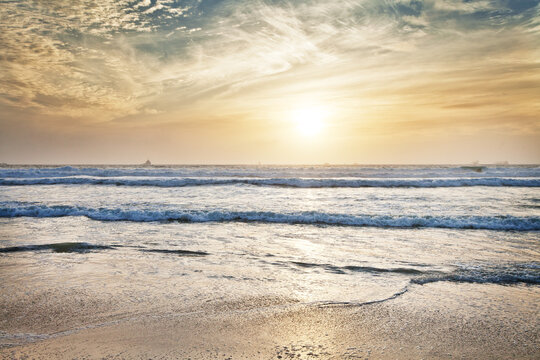 Beach, water and ocean with sunrise and mockup with blue sky and waves on horizon. Sea landscape, outdoor and nature with sunshine at the coast and seaside with sand and no people with clouds