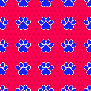 Blue Paw print icon isolated seamless pattern on red background. Dog or cat paw print. Animal track. Vector