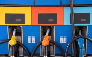 Close up of petrol fuel pistols at petrol station. - obrazy, fototapety, plakaty