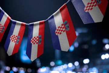 A garland of Croatia national flags on an abstract blurred background