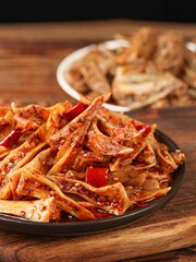 Fresh chicken cartilage,triquetral bone,Spicy dishes, Chinese food,Kitchen interior, dark background